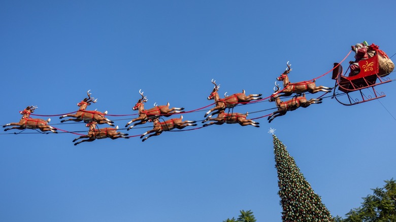A Santa Claus and reindeer Christmas decoration strung in the air