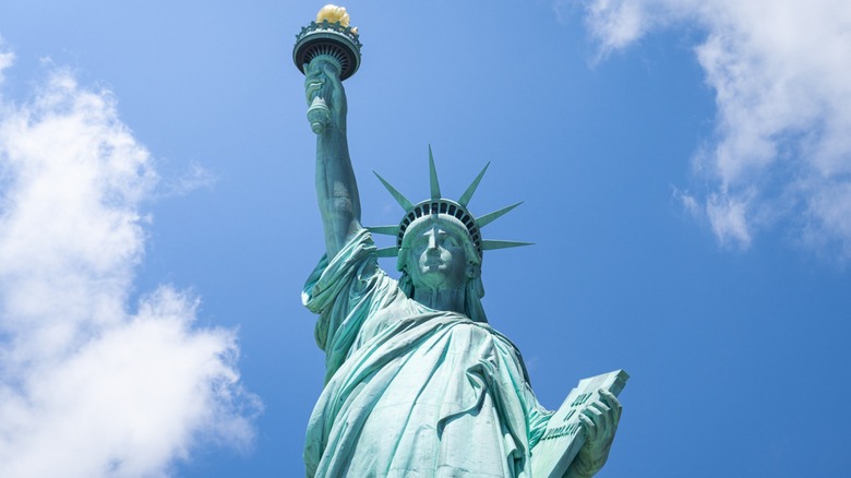 The Statue of Liberty set against the backdrop of a blue sky