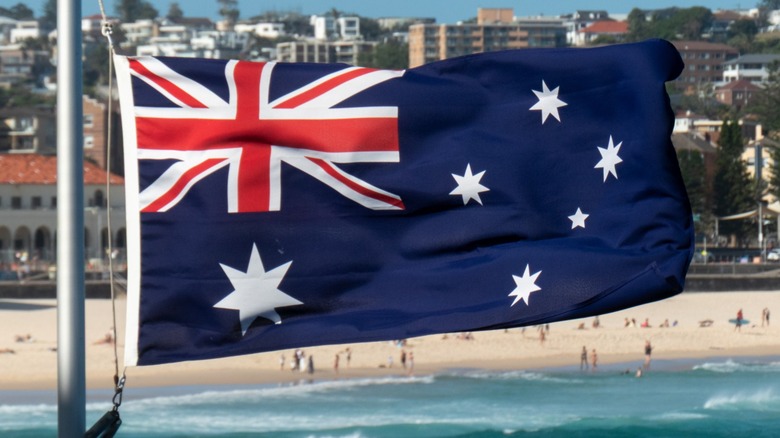 An Australian flag flying by a beach