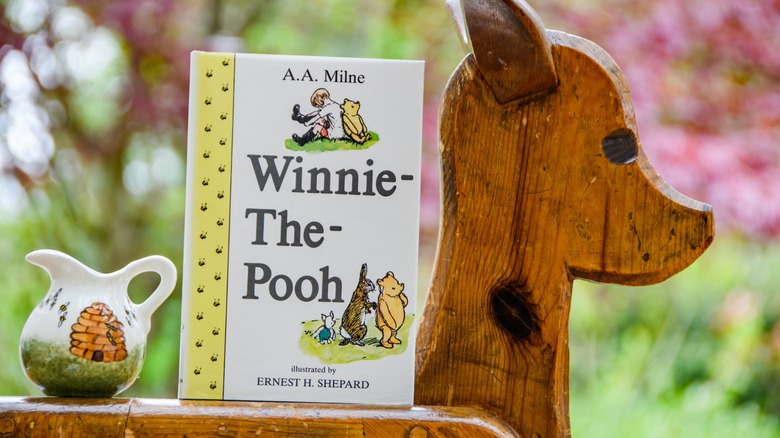 A Winnie The Pooh book on a rocking horse