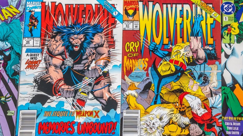 Two Wolverine comics amidst other comic books