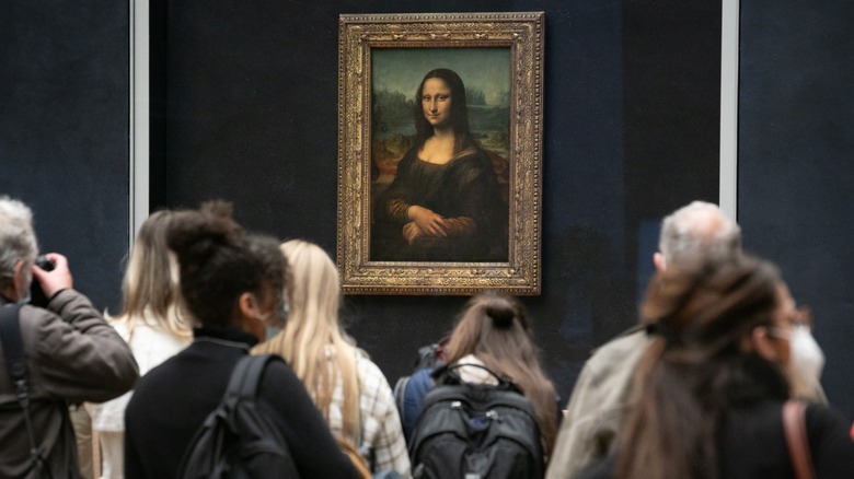 A group of people gathering around the Mona Lisa