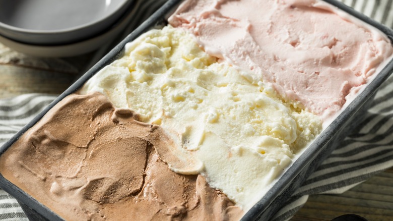 Neopolitan ice cream in a tub