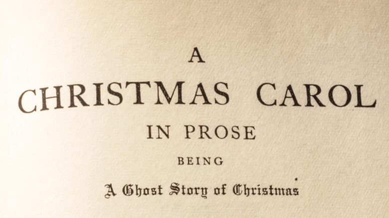 Charles Dickens' A Christmas Carol sitting on a shelf in front of other books