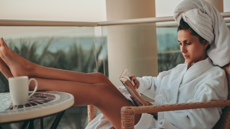 Woman reading book in robe