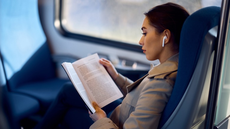 woman reading book outdoors