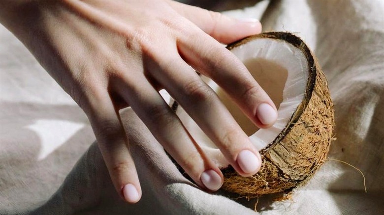 Woman reaching for coconut