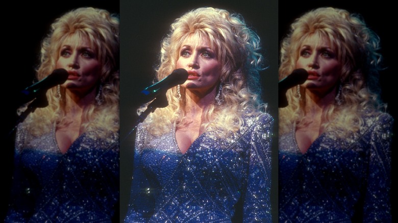 Dolly Parton performing in a sparkly blue corset top