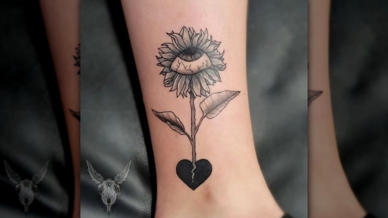 Floral broken heart tattoo with eye