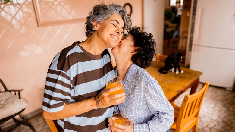 A woman kissing another woman on the cheek