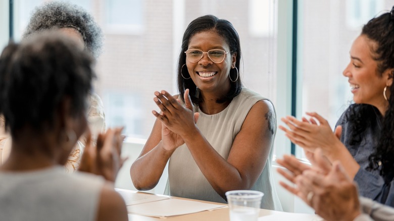 A woman smiling in a group of people