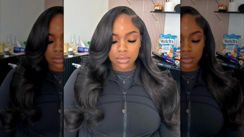 A woman with deeply side parted dark hair