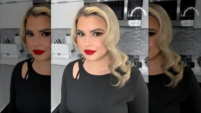 A woman with red lips and vintage blonde curls