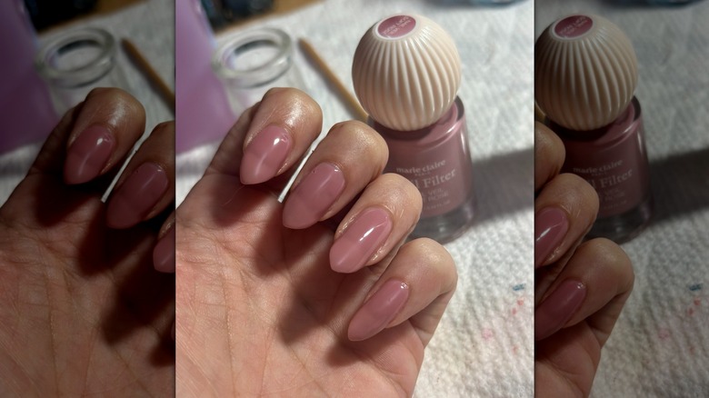 A semi-closed hand with a Marie Claire Paris nail polish bottle in the background showing the brand's rosy pink shade