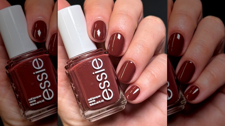 A close-up of a person's nails painted with Essie's Boho Rodeo and holding the nail polish bottle