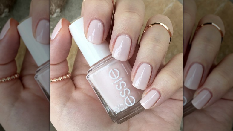 A close-up of a person's hands with Essie Ballet Slippers painted on their nails