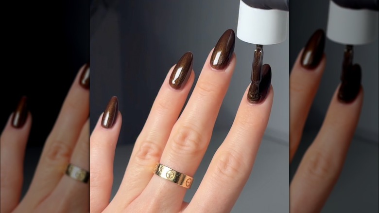 A still of someone applying OPI's Band Tease to long nails on Instagram