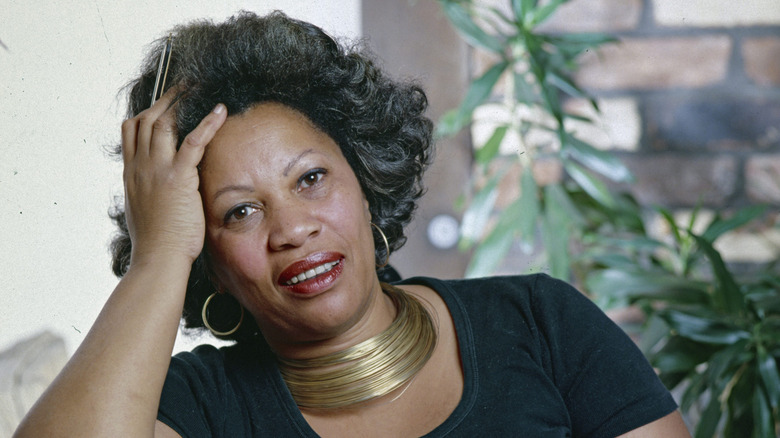 Toni Morrison in a black tshirt and wearing gold necklaces