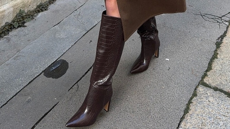 A person wearing dark brown boots