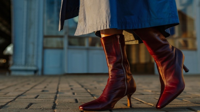 A woman wearing maroon boots