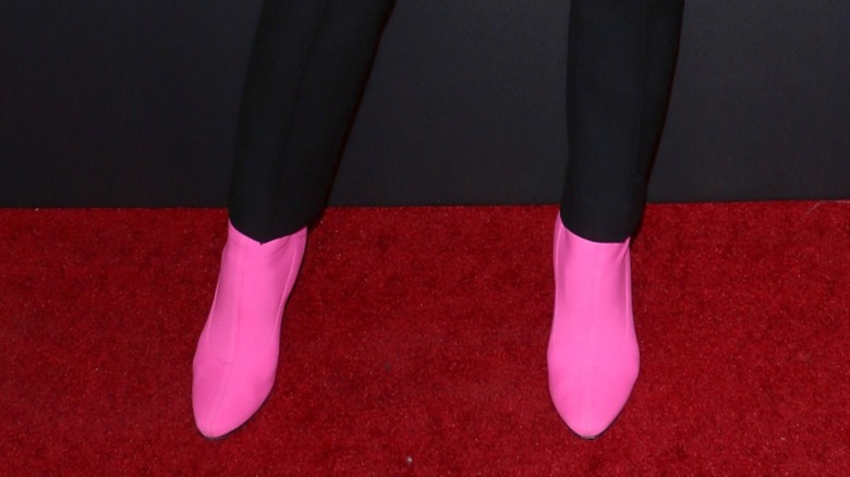 A woman wearing hot pink boots