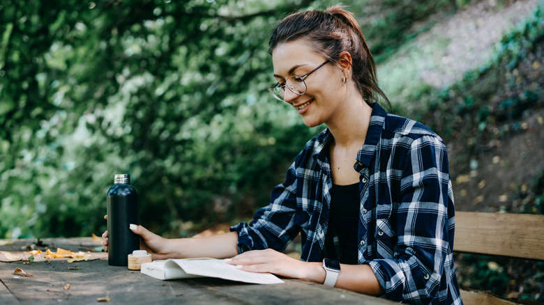 Woman reading in the woods