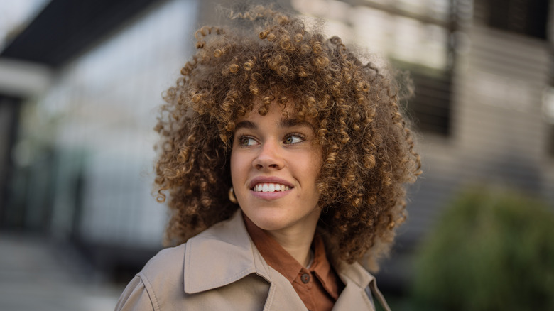 Woman with brown curly hair