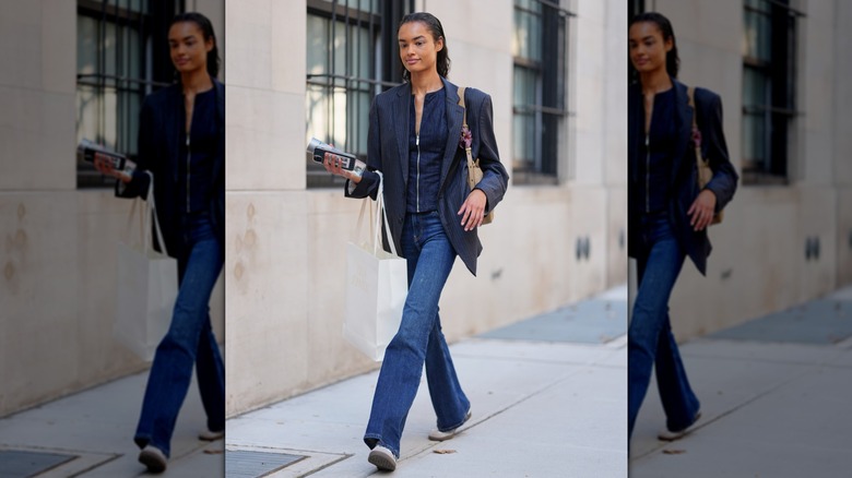 A woman wearing dark wash denim with a blazer in New York