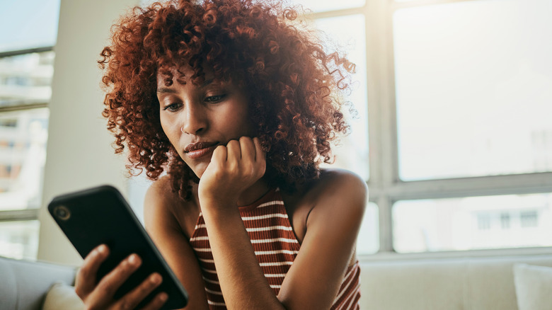 woman looking at her phone