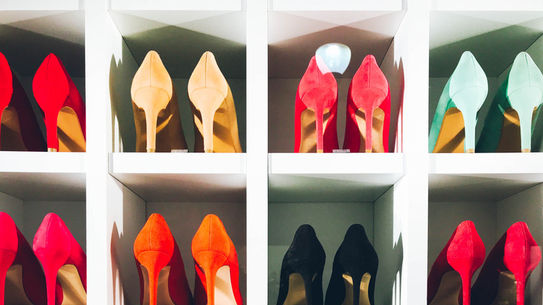 Heels in a variety of colors sitting in white cubies