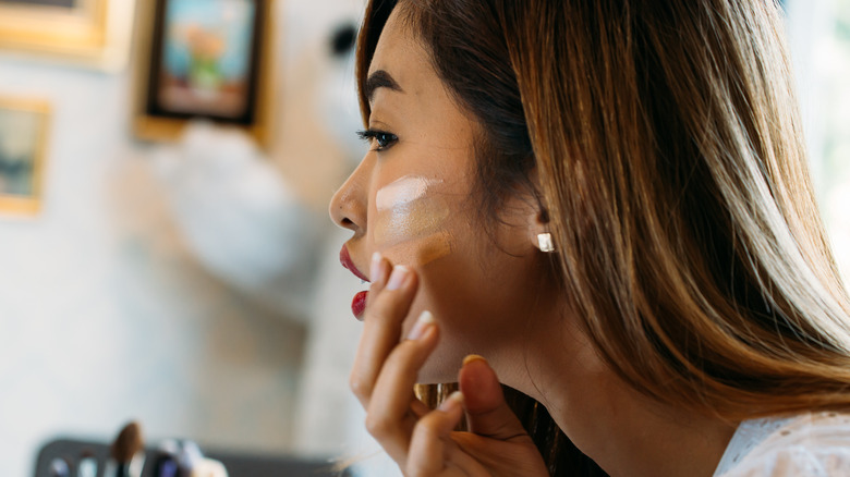 Woman testing foundation shades