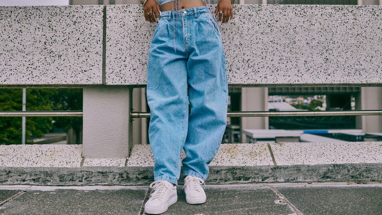 Model wearing baggy denim pants