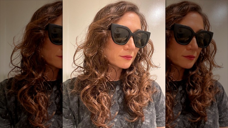 A woman with longer, curled hair