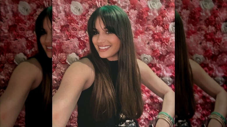 A woman with longer hair and Birkin bangs
