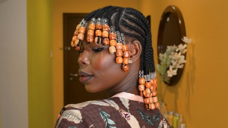 A woman with braided hair and beads