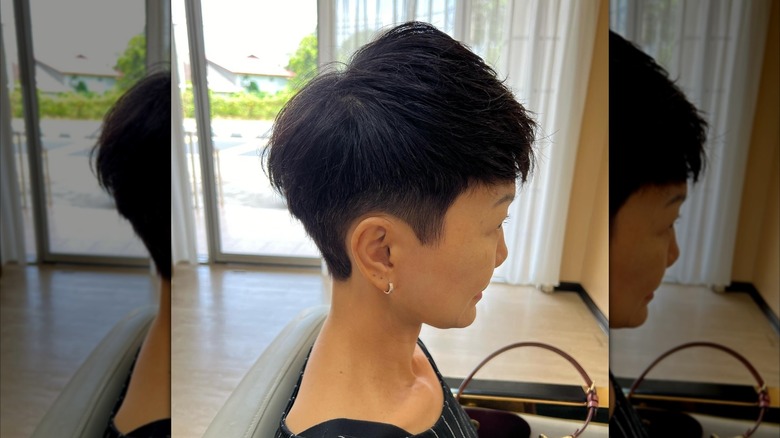 A woman with a short, choppy cut with shaved sides