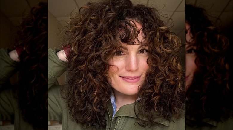 A woman with layered, curly hair