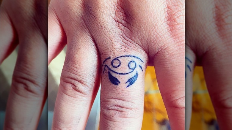 Crab finger tattoo