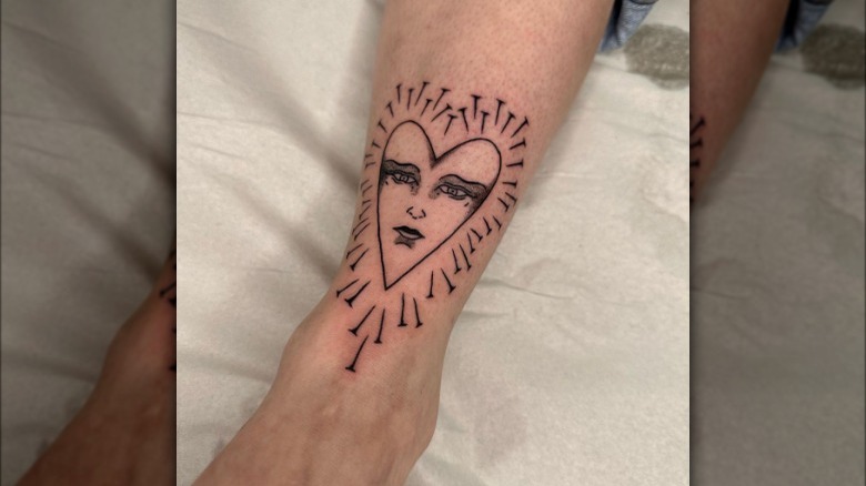 Heart and nails tattoo