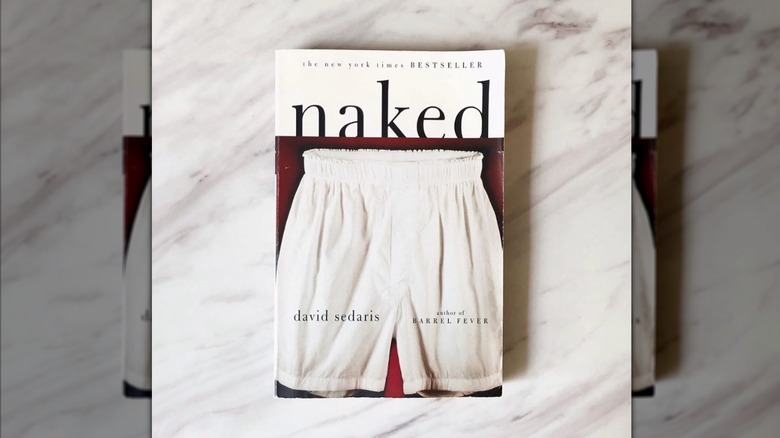 A copy of the book "Naked" laying on a marble table