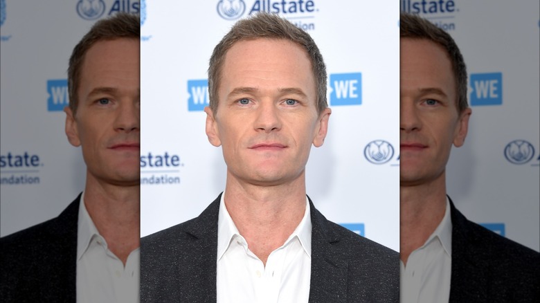 Neil Patrick Harris wearing a gray suit on the red carpet
