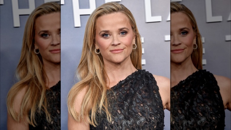 Reese Witherspoon wearing a gray dress on the red carpet