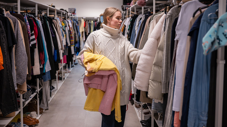 Woman shopping for thrifted coats