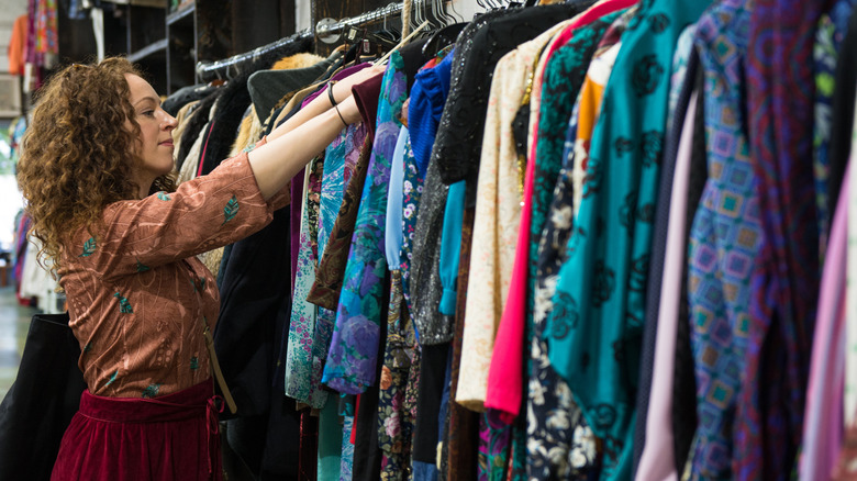 Woman shopping for dresses at a thrift store