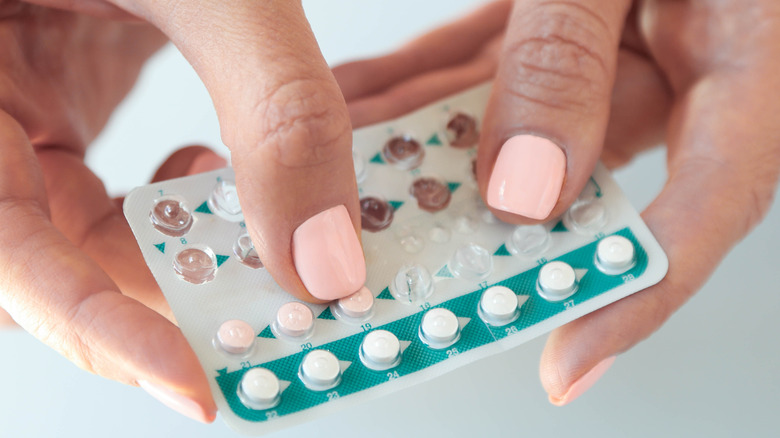 Someone holding birth control pills