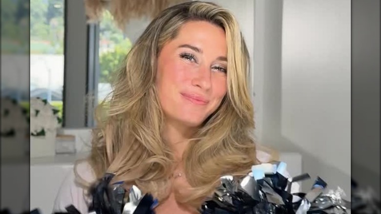 A woman with a bouncy blowout hairdo