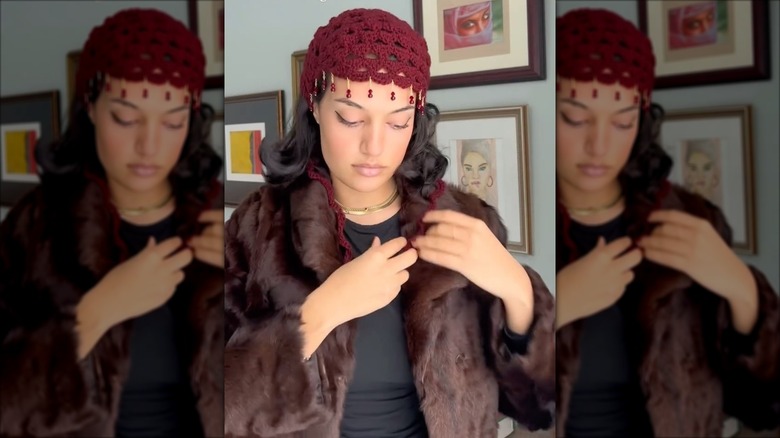 A woman wearing a crochet head piece