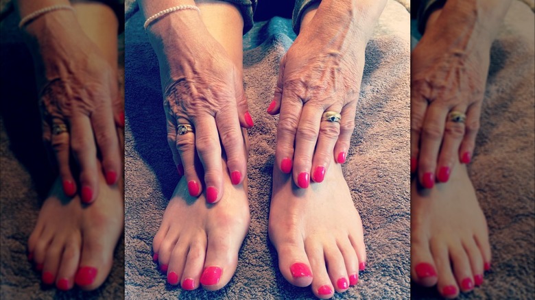 A woman with raspberry nails and toes