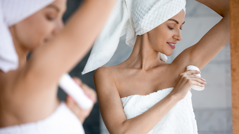 Woman applying deodorant