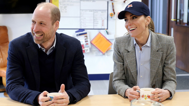 Kate Middleton and Prince William speak with crew members during their visit to the RNLI Tower Station on March 12, 2026 in London